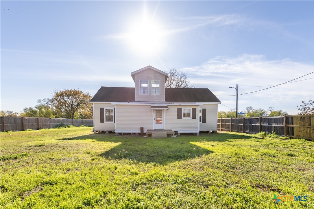 1002 East Commercial Street Victoria, TX 77901 - Photo 24 of 30 a view of a house with a big yard and potted plants