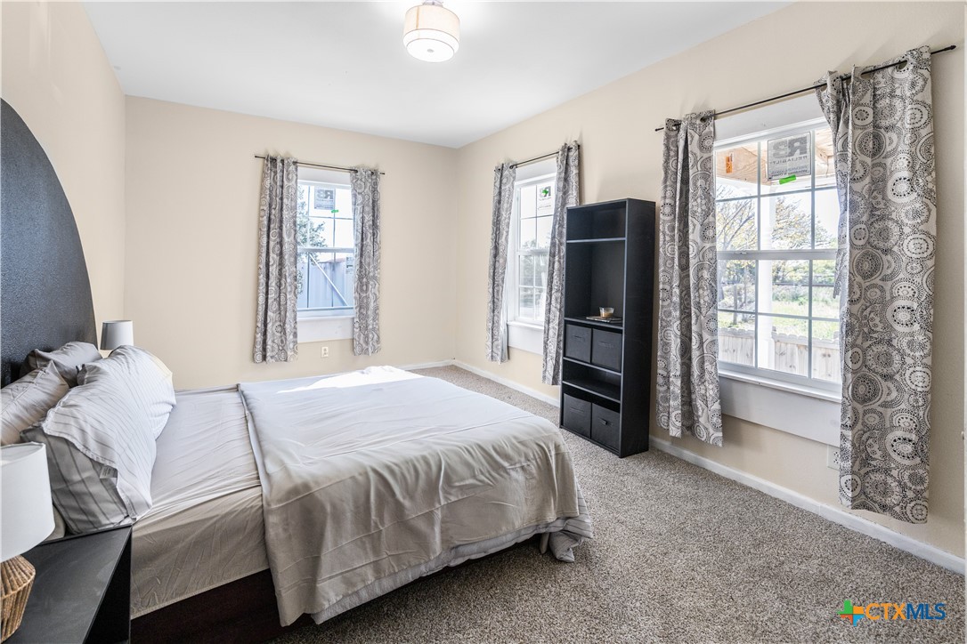 1002 East Commercial Street Victoria, TX 77901 - Photo 4 of 30 a bedroom with a bed and a window