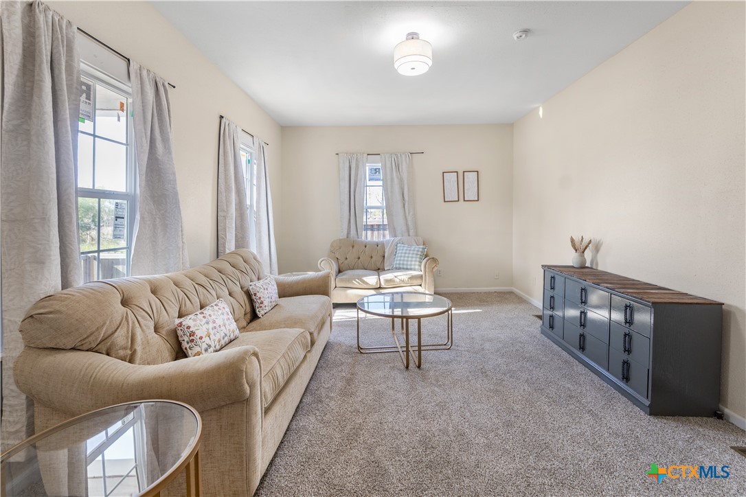 1002 East Commercial Street Victoria, TX 77901 - Photo 5 of 30 a living room with furniture and a large window