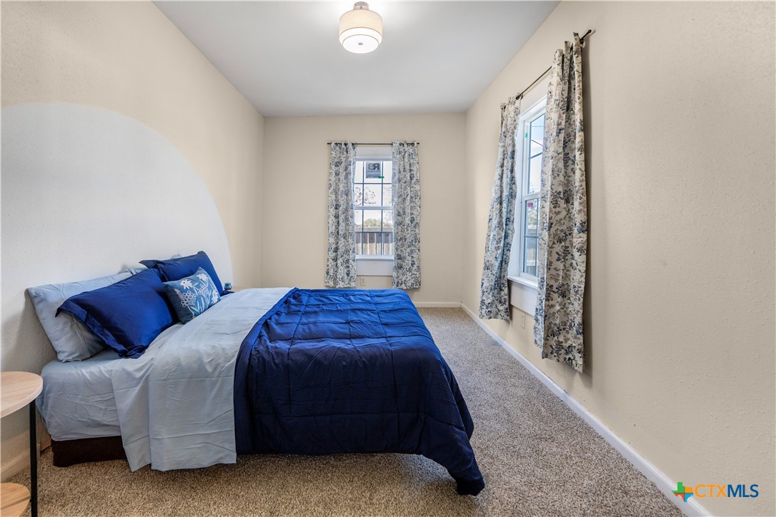 1002 East Commercial Street Victoria, TX 77901 - Photo 9 of 30 a bedroom with a bed and a window