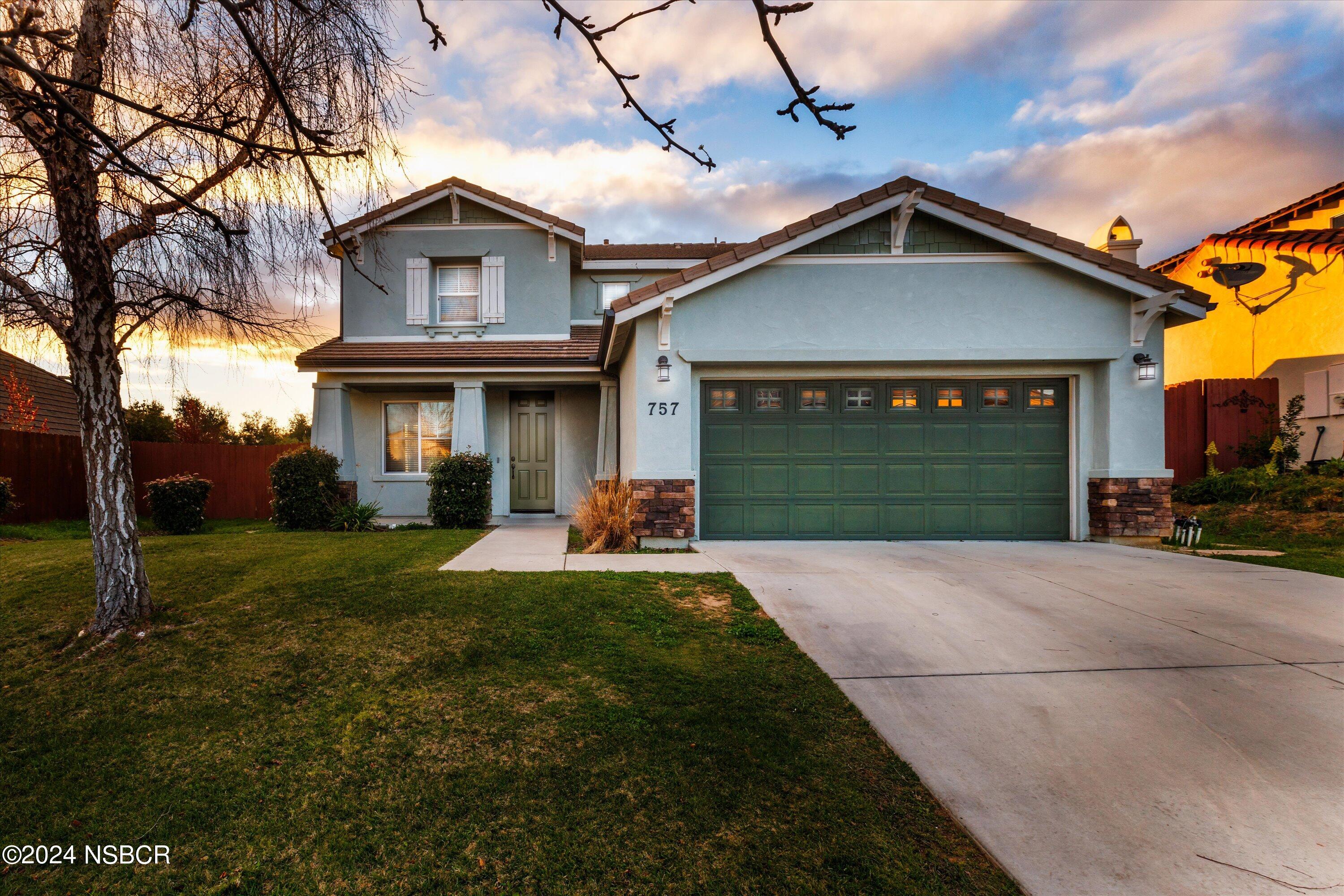 757 Pluto Avenue Lompoc, CA 93436 - Photo 1 of 41 a front view of a house with a yard and garage