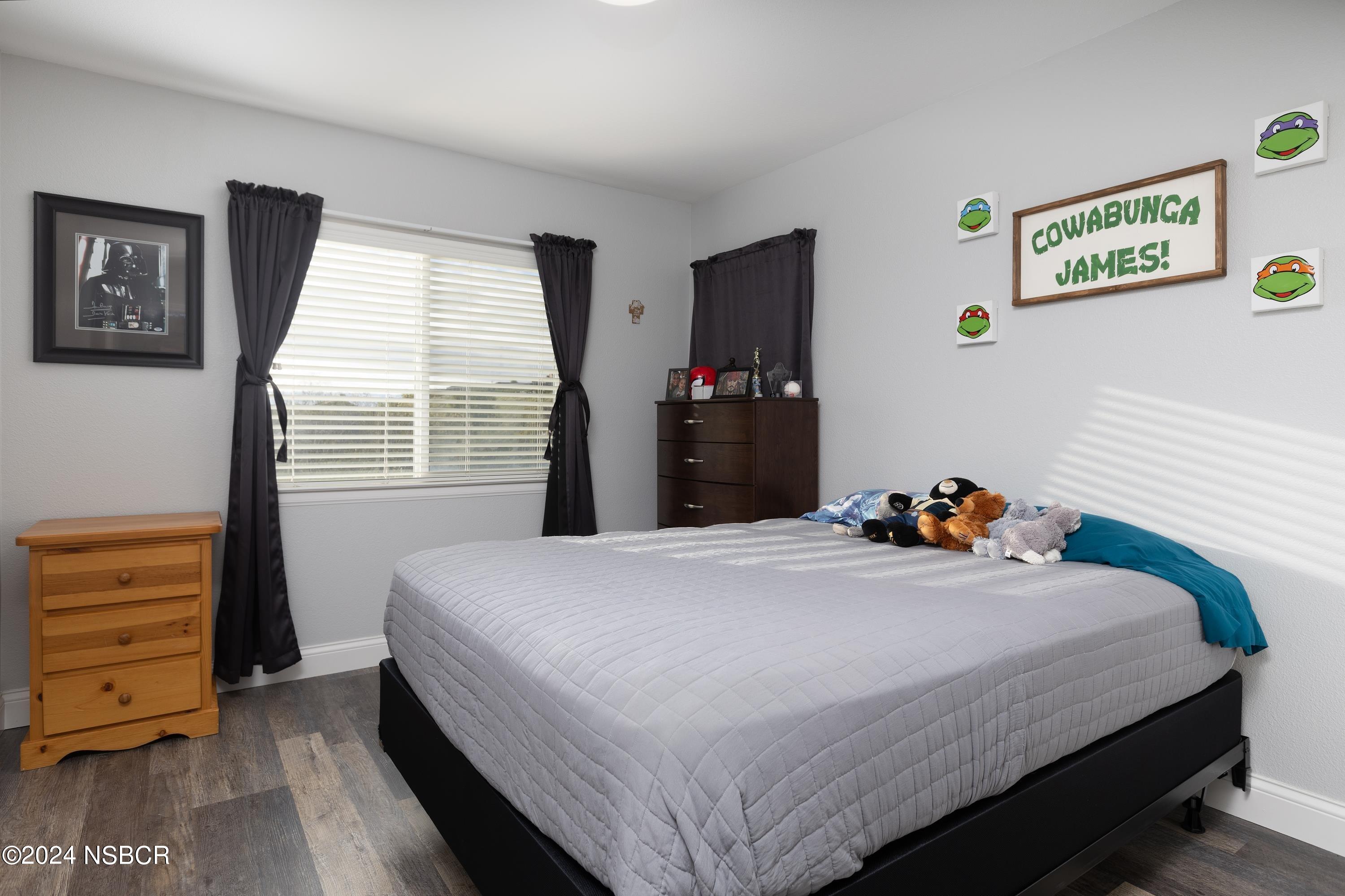 757 Pluto Avenue Lompoc, CA 93436 - Photo 18 of 41 a bedroom with a bed and wooden floor