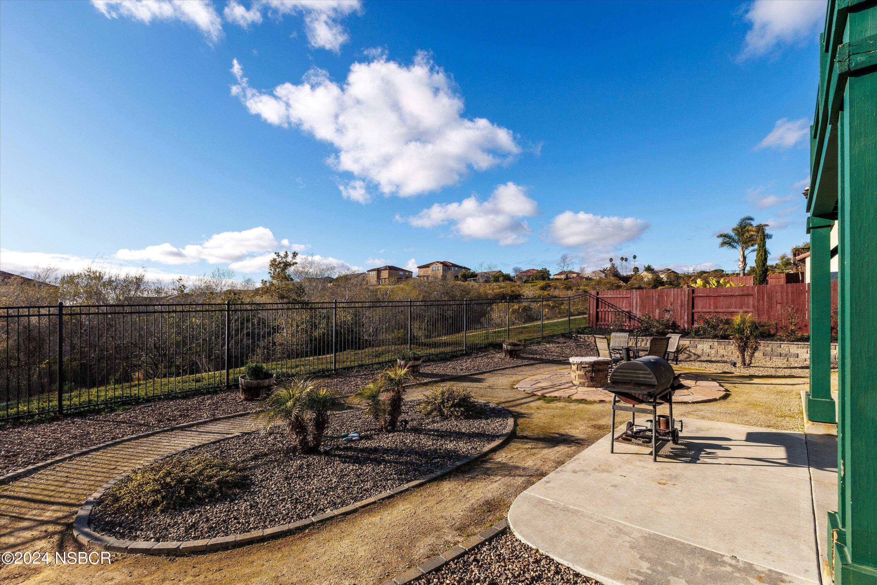 757 Pluto Avenue Lompoc, CA 93436 - Photo 23 of 41 a view of a swimming pool with a patio and a garden