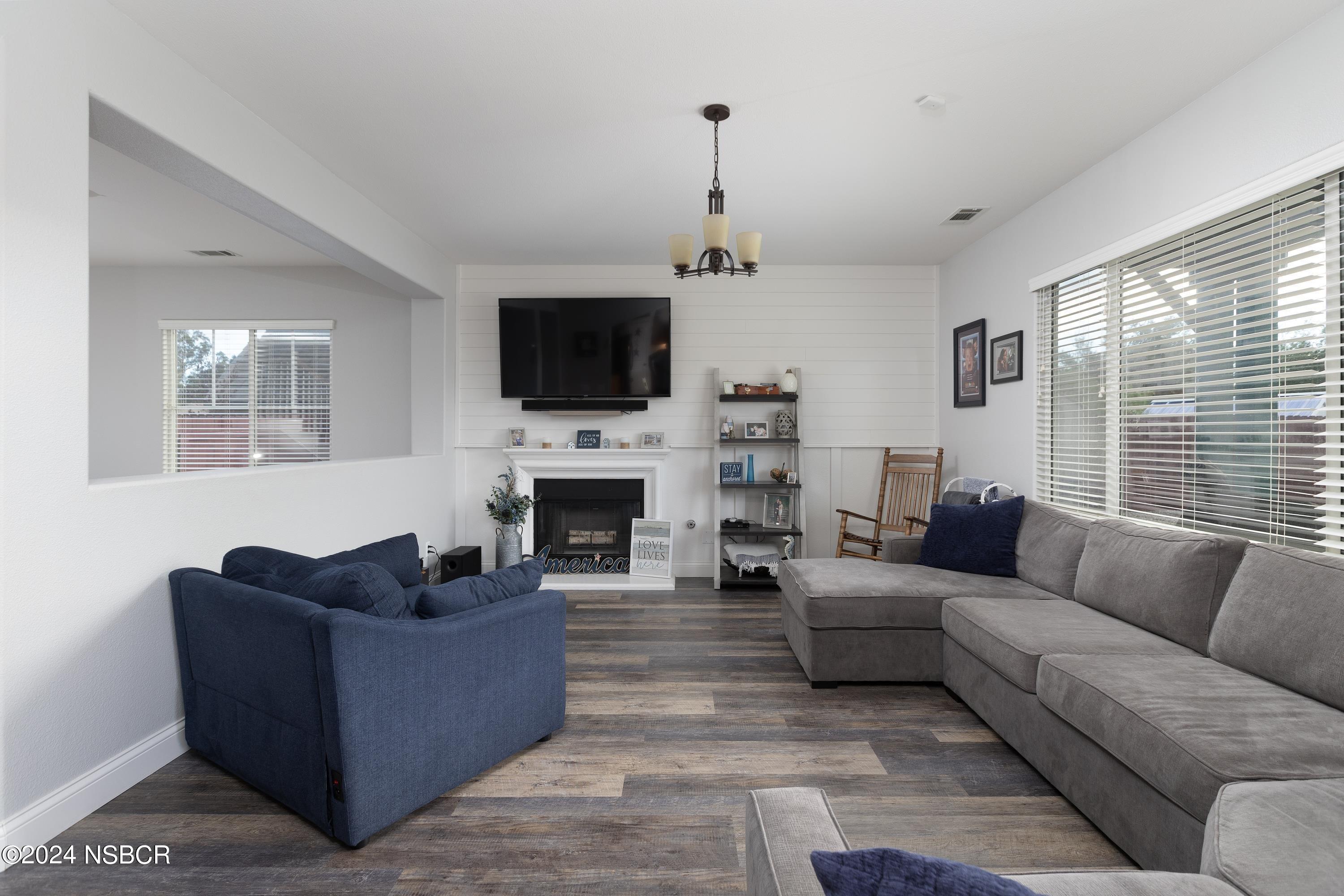 757 Pluto Avenue Lompoc, CA 93436 - Photo 4 of 41 a living room with furniture a fireplace and a flat screen tv