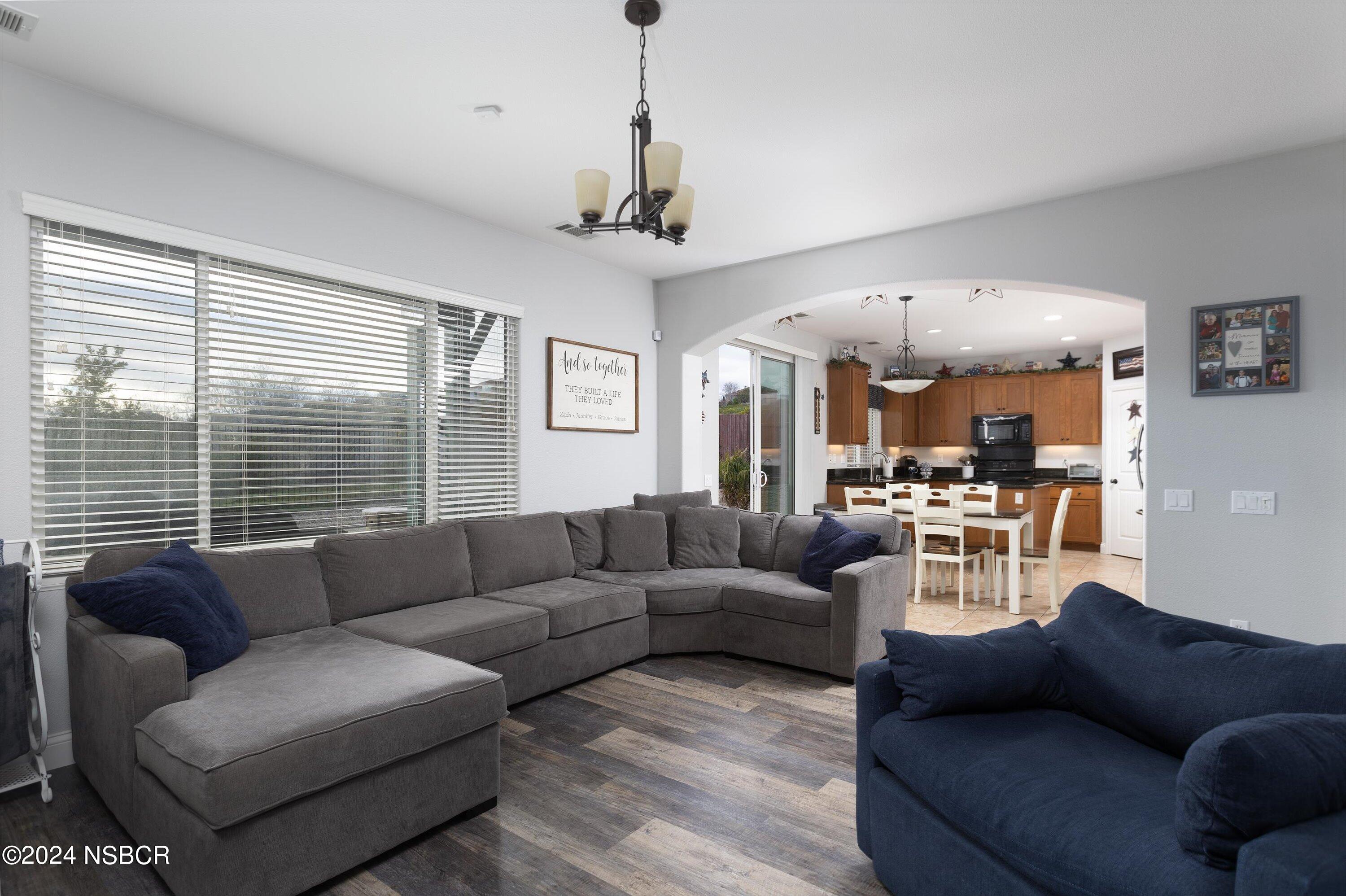 757 Pluto Avenue Lompoc, CA 93436 - Photo 5 of 41 a living room with furniture ceiling fan and a large window