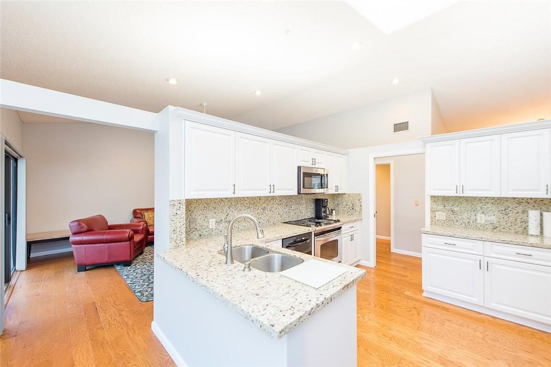 3976 Northwest 23rd Terrace Boca Raton, FL 33431 - Photo 12 of 31 a kitchen with a stove a sink and a refrigerator