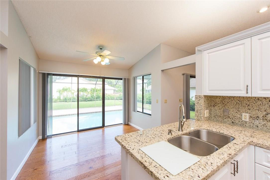 3976 Northwest 23rd Terrace Boca Raton, FL 33431 - Photo 15 of 31 a kitchen with a stove a sink and a large window