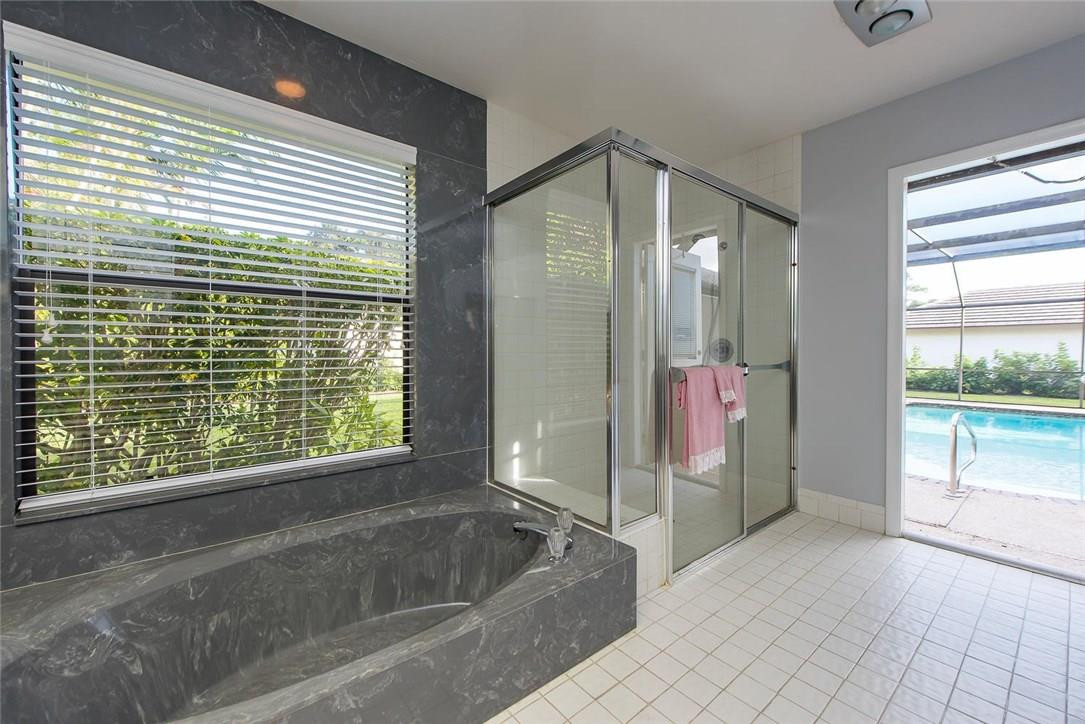 3976 Northwest 23rd Terrace Boca Raton, FL 33431 - Photo 21 of 31 a bathroom with a bathtub and shower