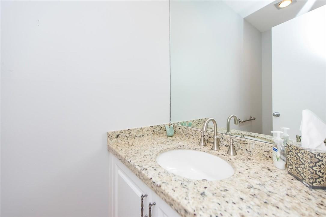 3976 Northwest 23rd Terrace Boca Raton, FL 33431 - Photo 27 of 31 a bathroom with a granite countertop sink and a mirror
