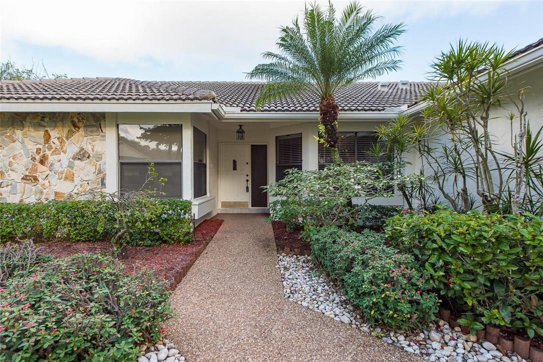 3976 Northwest 23rd Terrace Boca Raton, FL 33431 - Photo 6 of 31 a front view of a house with a garden