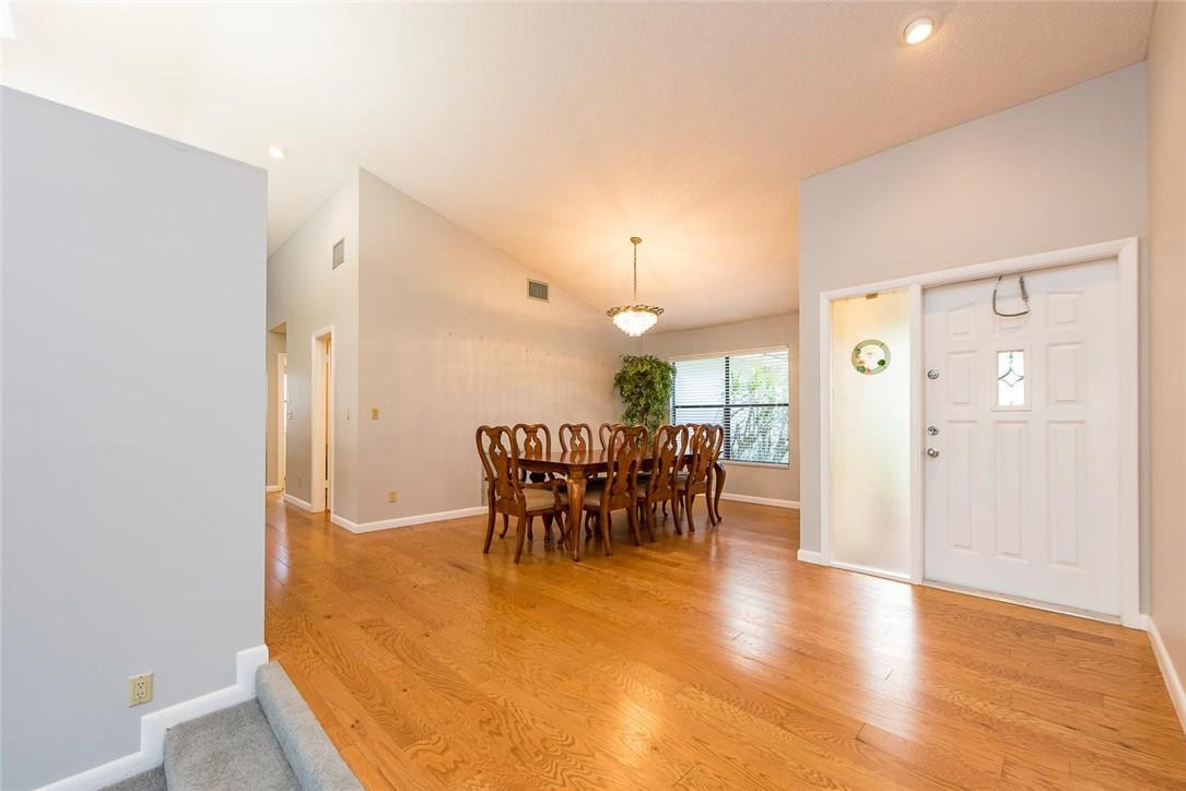 3976 Northwest 23rd Terrace Boca Raton, FL 33431 - Photo 10 of 31 a view of a dining room with furniture and chandelier