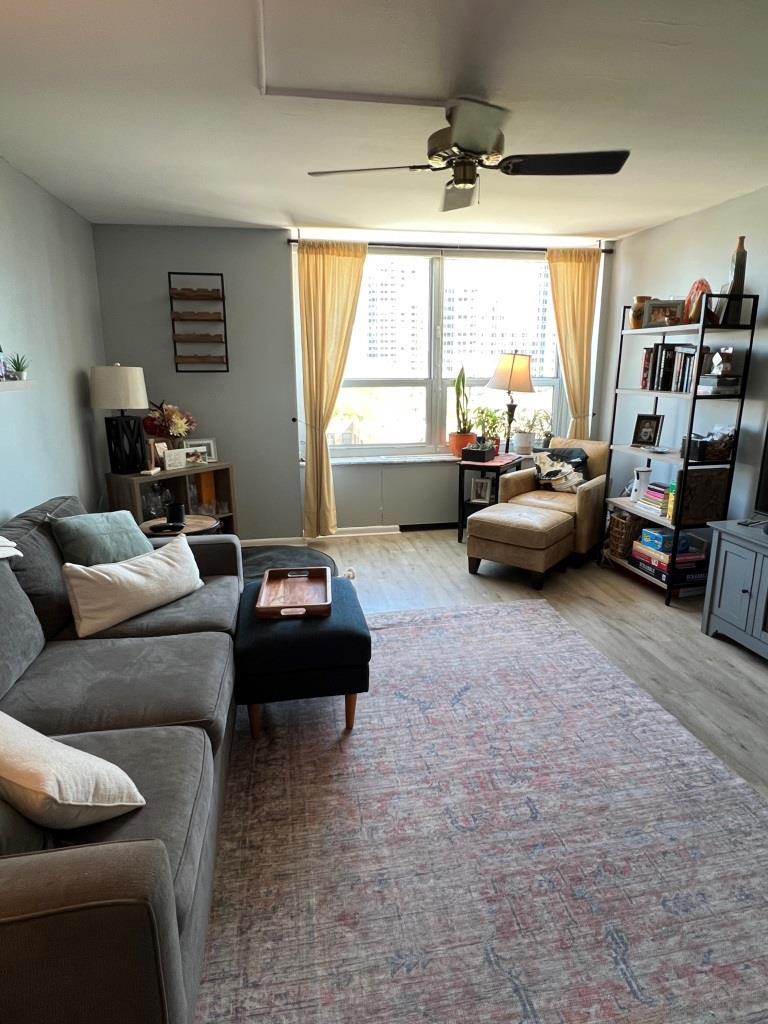720 West Gordon Terrace, Unit 7F Chicago, IL 60613 - Photo 2 of 19 a living room with furniture and a large window