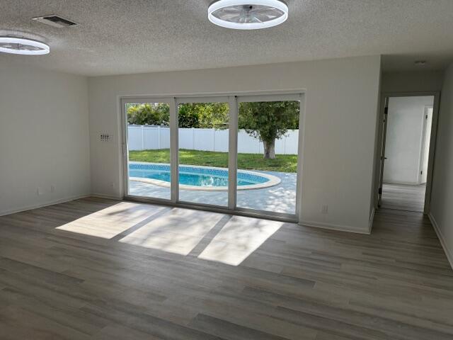 28 Southwest 9th Avenue Boca Raton, FL 33486 - Photo 7 of 16 a view of an empty room with wooden floor and a window