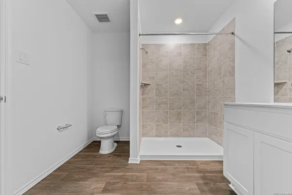 a bathroom with a shower a toilet and a shower