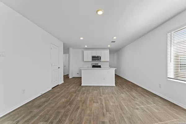a view of kitchen with cabinets and wooden floor