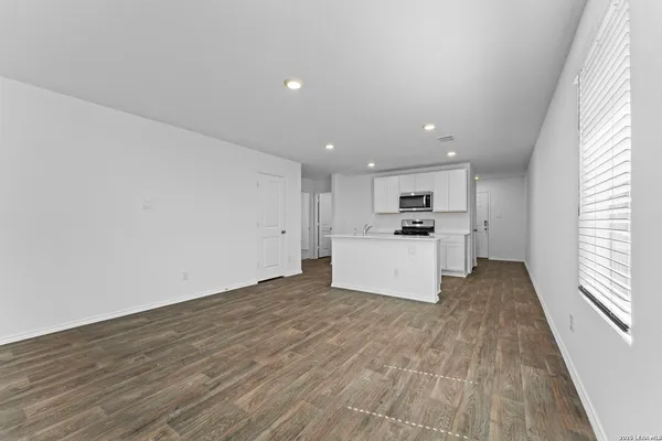 a view of a kitchen with microwave and cabinets
