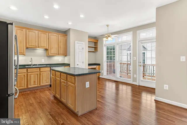a kitchen with stainless steel appliances granite countertop a stove top oven and a refrigerator