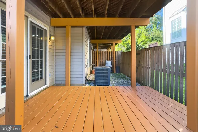 a view of a deck with a table and chairs with wooden floor and fence