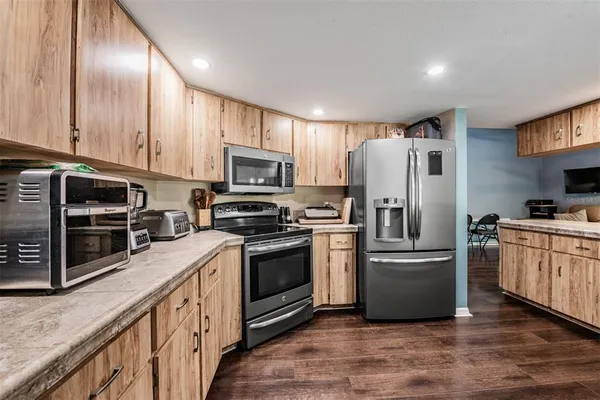 a kitchen with stainless steel appliances granite countertop a refrigerator stove a sink and dishwasher