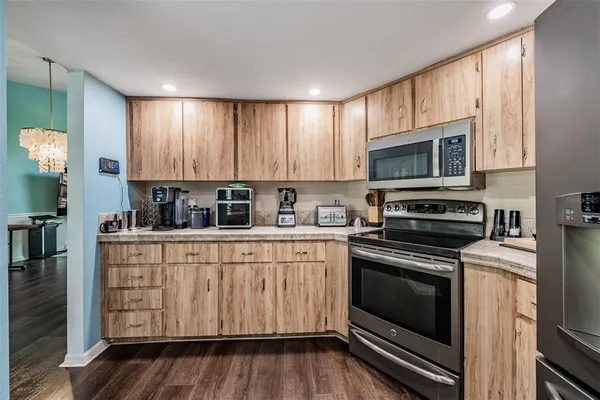a kitchen with stainless steel appliances a stove a microwave sink and cabinets