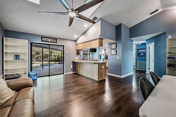 a view of a livingroom with furniture wooden floor and windows