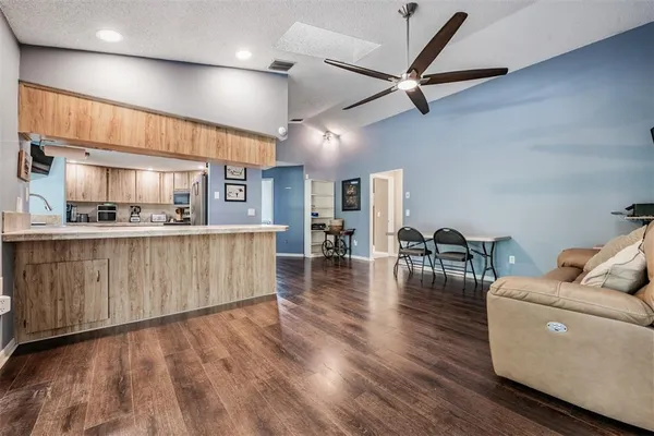 a living room with kitchen island furniture and a wooden floor
