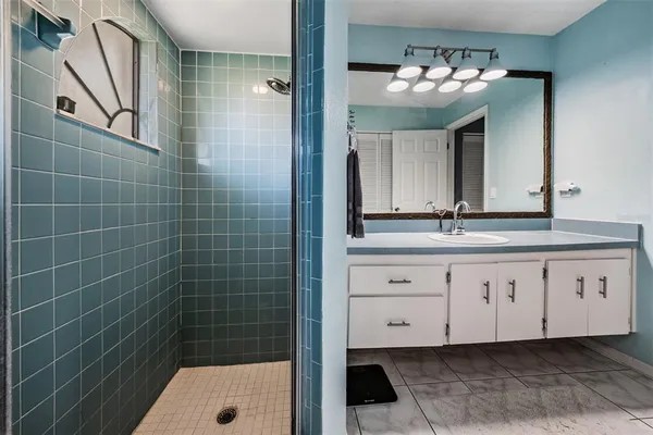 a bathroom with a bathtub and a shower