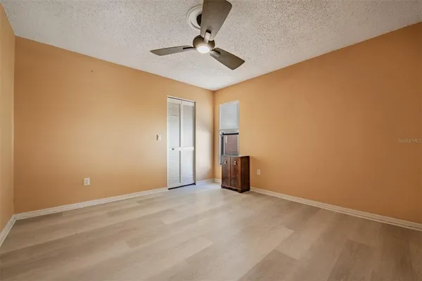 a bedroom with a bed and a ceiling fan