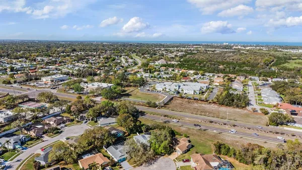 a view of a house with a yard and garden