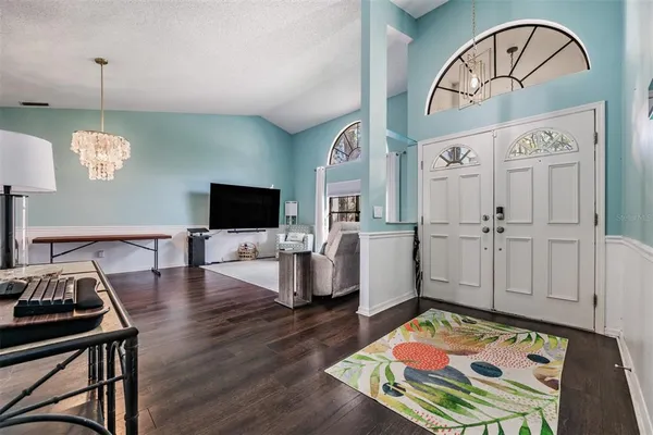 a bedroom with furniture and a flat screen tv
