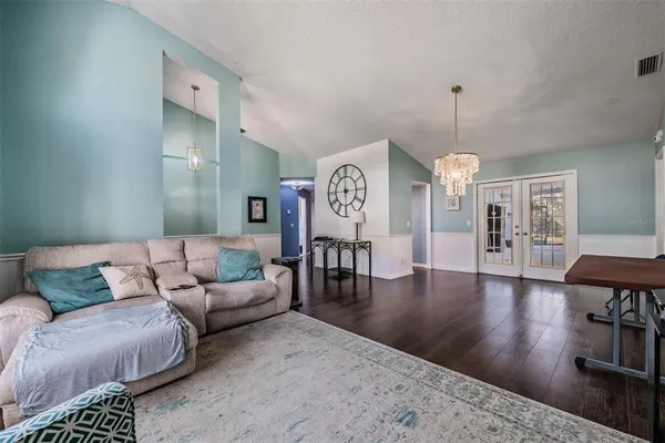 a living room with furniture and wooden floor