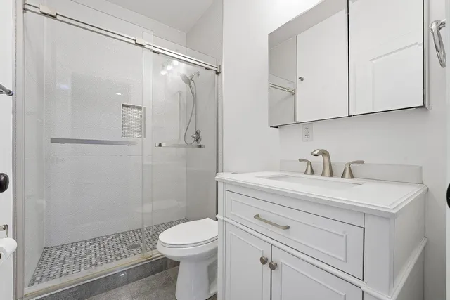 a view of bathroom with a sink mirror and toilet