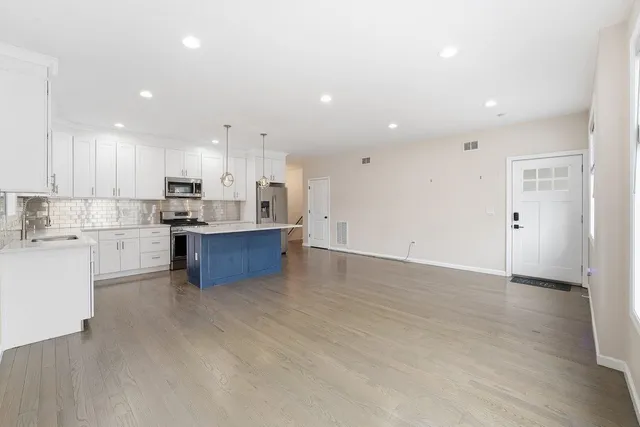 a kitchen with a refrigerator and a stove top oven