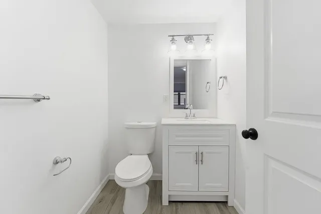 a bathroom with a toilet a sink and mirror