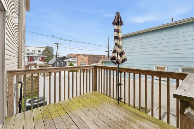 a view of a balcony with wooden floor