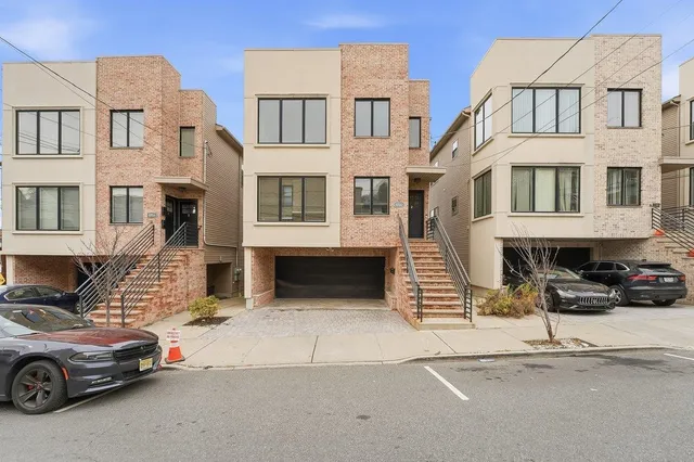 a car parked in front of a white building