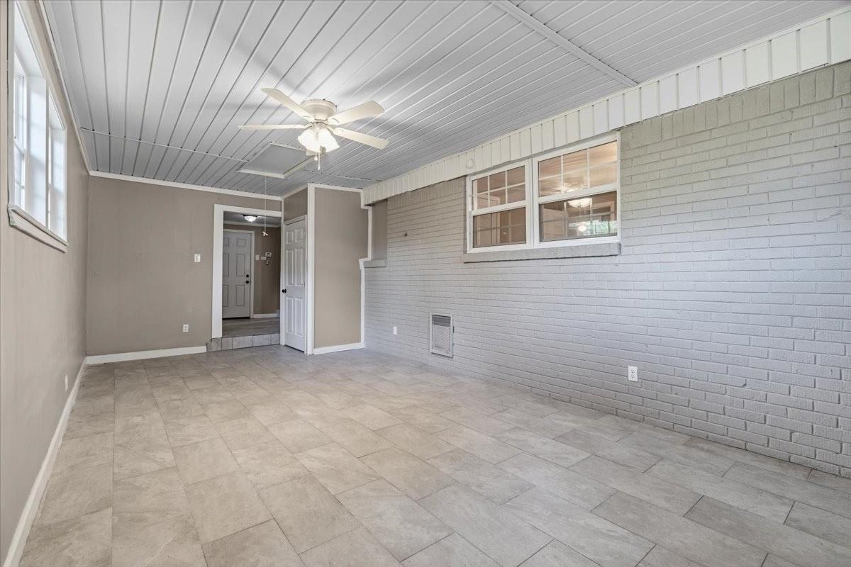 1176 South White Station Road Memphis, TN 38117 - Photo 11 of 15 Spacious room featuring light gray tile flooring and a white paneled ceiling