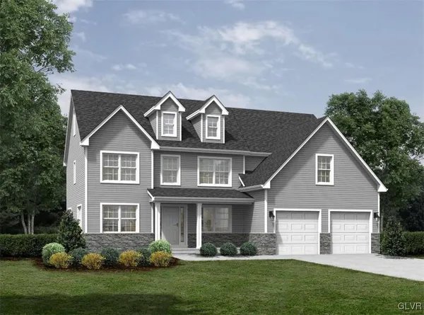 a front view of a house with a yard and green space