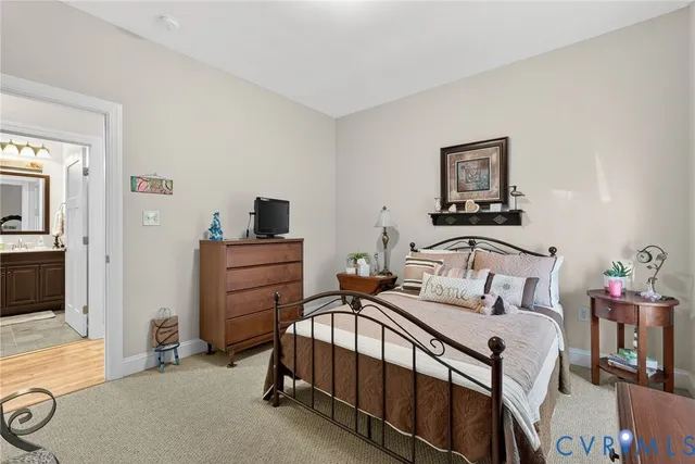 a bedroom with a bed and a tv on the dresser