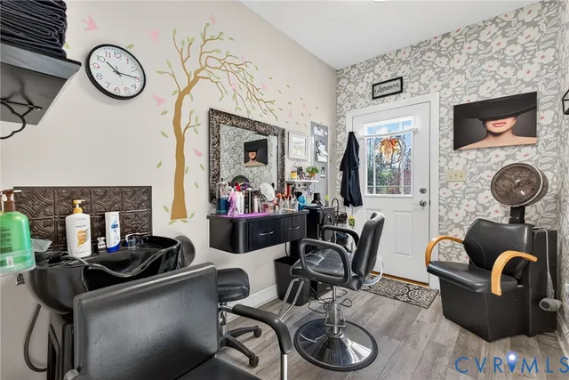 a living room with furniture a flat screen tv and a wall clock