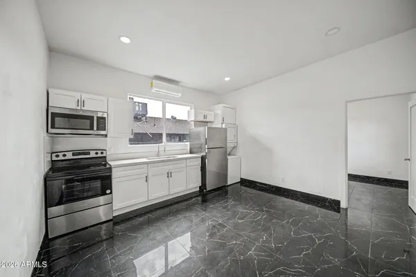 a kitchen with a sink appliances and cabinets