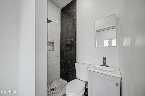 a white toilet sitting next to a bathroom sink