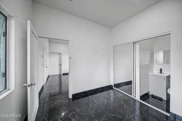 a view of a room with wooden floor and a cabinet