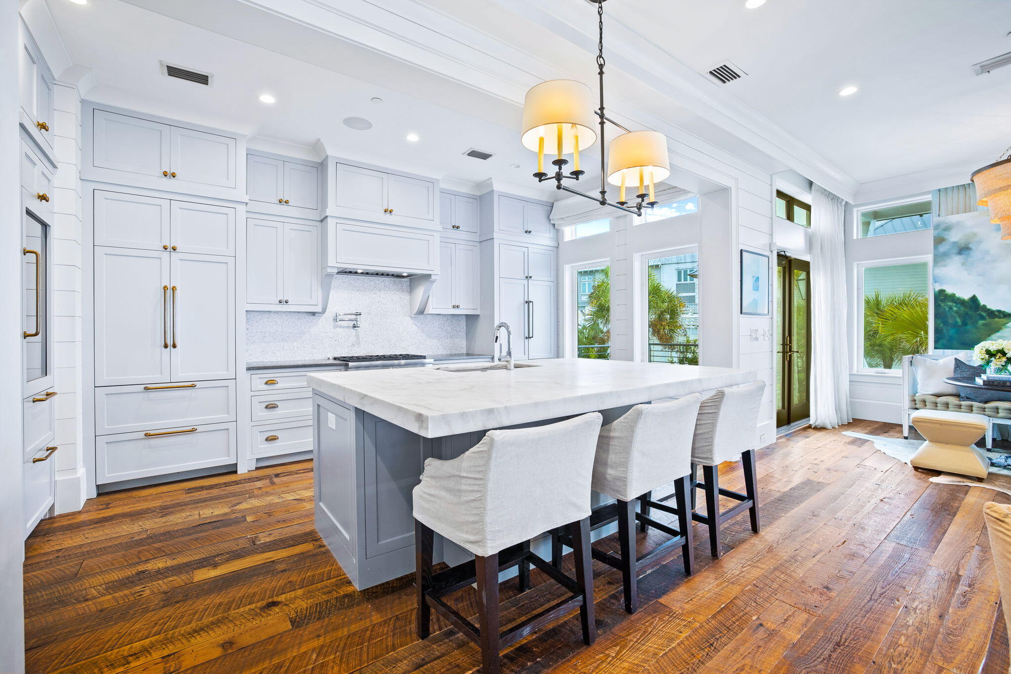376 Beachfront Trail Santa Rosa Beach, FL 32459 - Photo 11 of 62 an open kitchen with granite countertop a stove a sink a dining table and chairs with wooden floor