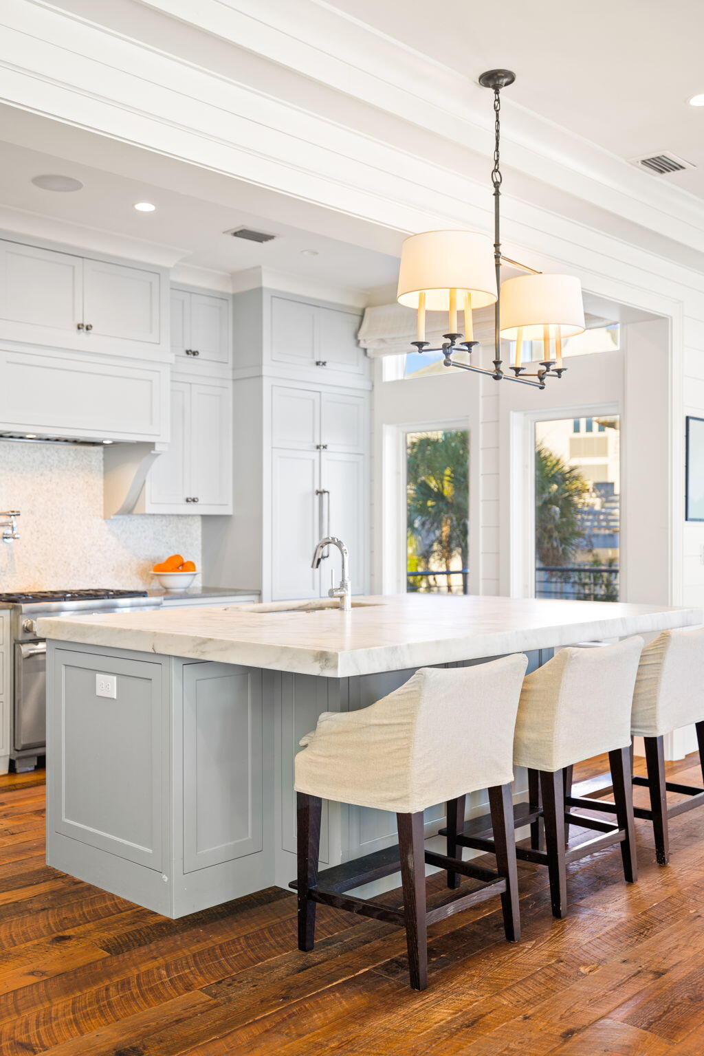 376 Beachfront Trail Santa Rosa Beach, FL 32459 - Photo 13 of 62 a kitchen with stainless steel appliances a table chairs in it white cabinets and a wooden floors