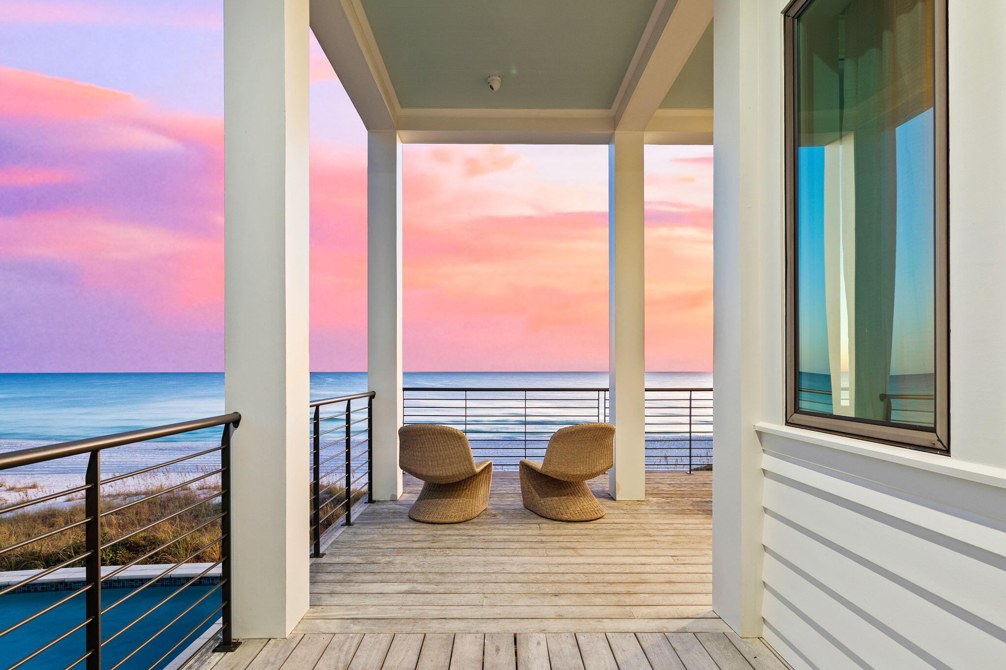 376 Beachfront Trail Santa Rosa Beach, FL 32459 - Photo 21 of 62 a view of a balcony with floor to ceiling windows with wooden floor