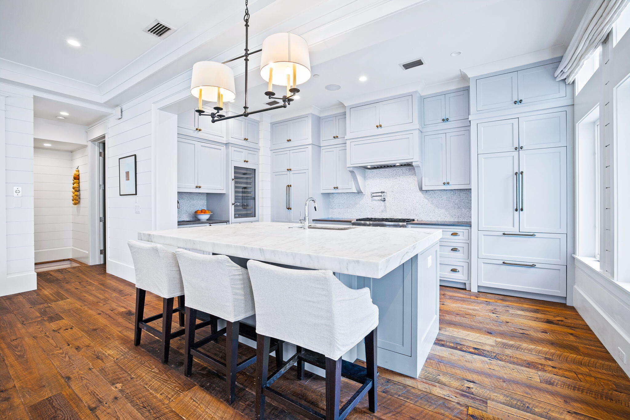 376 Beachfront Trail Santa Rosa Beach, FL 32459 - Photo 10 of 62 a kitchen with stainless steel appliances kitchen island granite countertop a table chairs and wooden floor