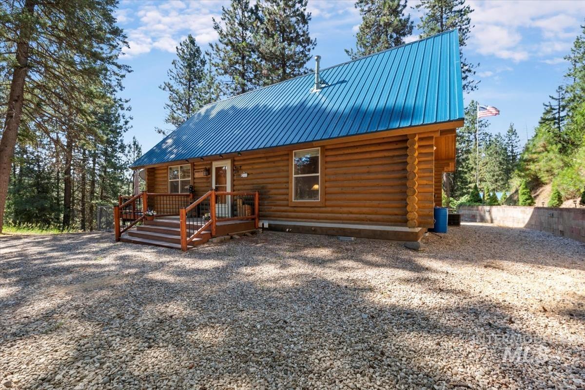 10 Elk Point Road Garden Valley, ID 83622 - Photo 7 of 42 View of front of property featuring log exterior, a metal roof, and a wooden deck