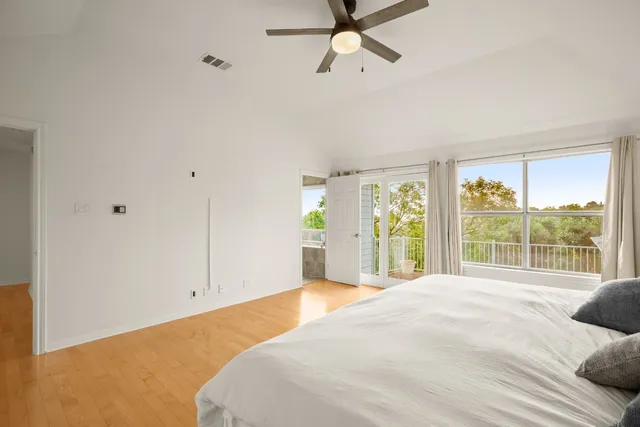 a bedroom with a bed and a large window