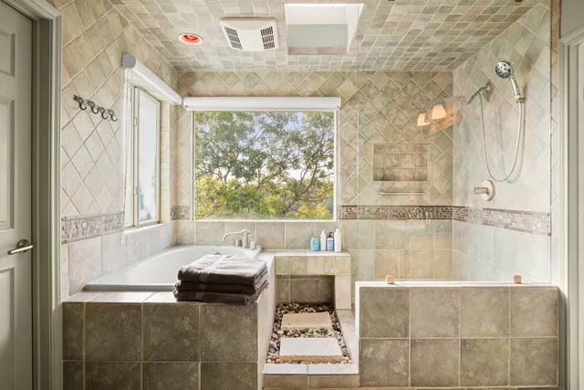 a bathroom with a bathtub and shower